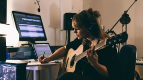 Woman Recording Guitars in Her Home Sound Studio